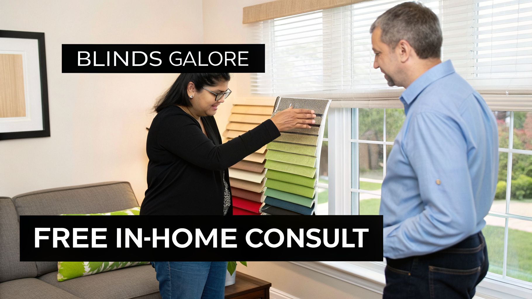 A woman assists a man in choosing window blinds, showcasing fabric samples during an in-home consultation.