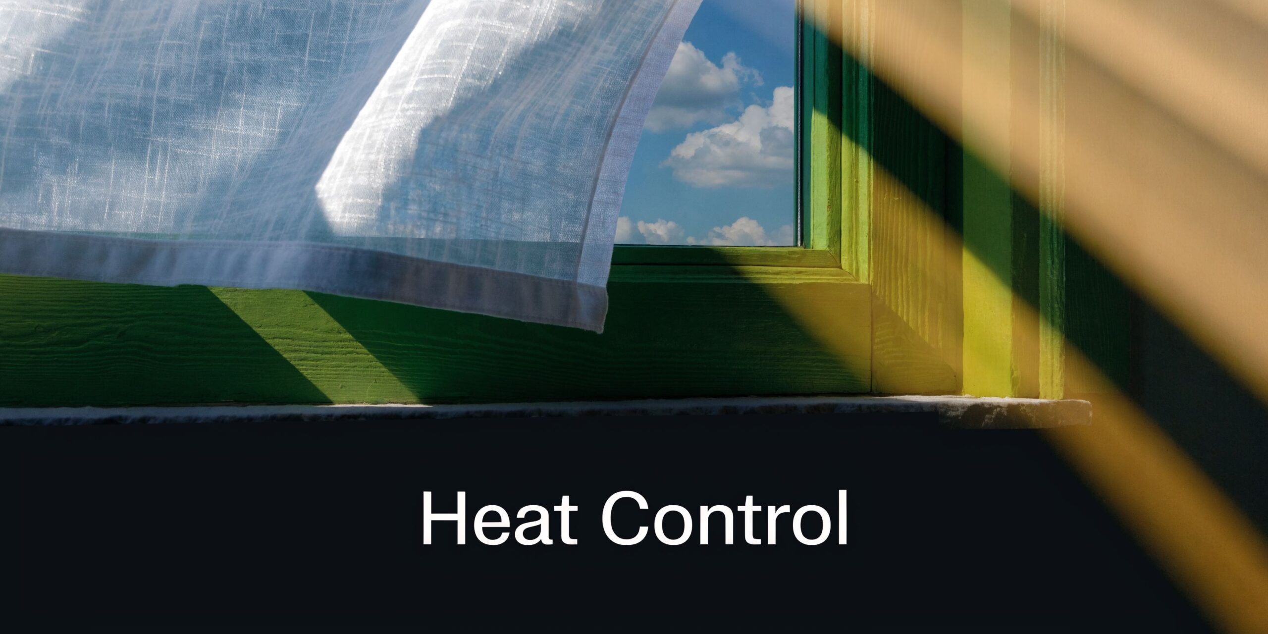 A bright sunlight shining through a window with a sheer curtain, illustrating effective heat control solutions.